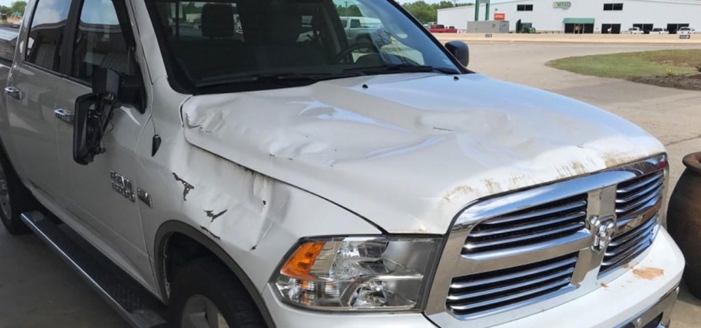 Before photo of a Dodge pickup truck with collision damage.